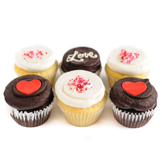 half dozen Valentine's Day cupcakes with hearts and sprinkles