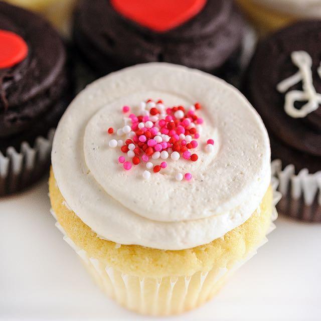 close up of vanilla cupcake with red, white and pink sprinkles